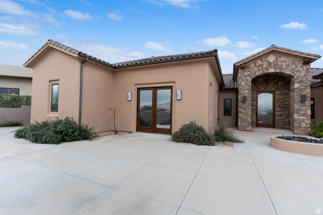 2464 East Granite Way St. George, UT 84790 - Photo 12 of 106 View of front of home featuring french doors, stucco siding, stone siding, and a tile roof