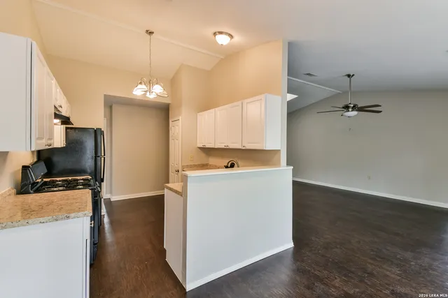 a view of a kitchen with a sink wooden floor and a window
