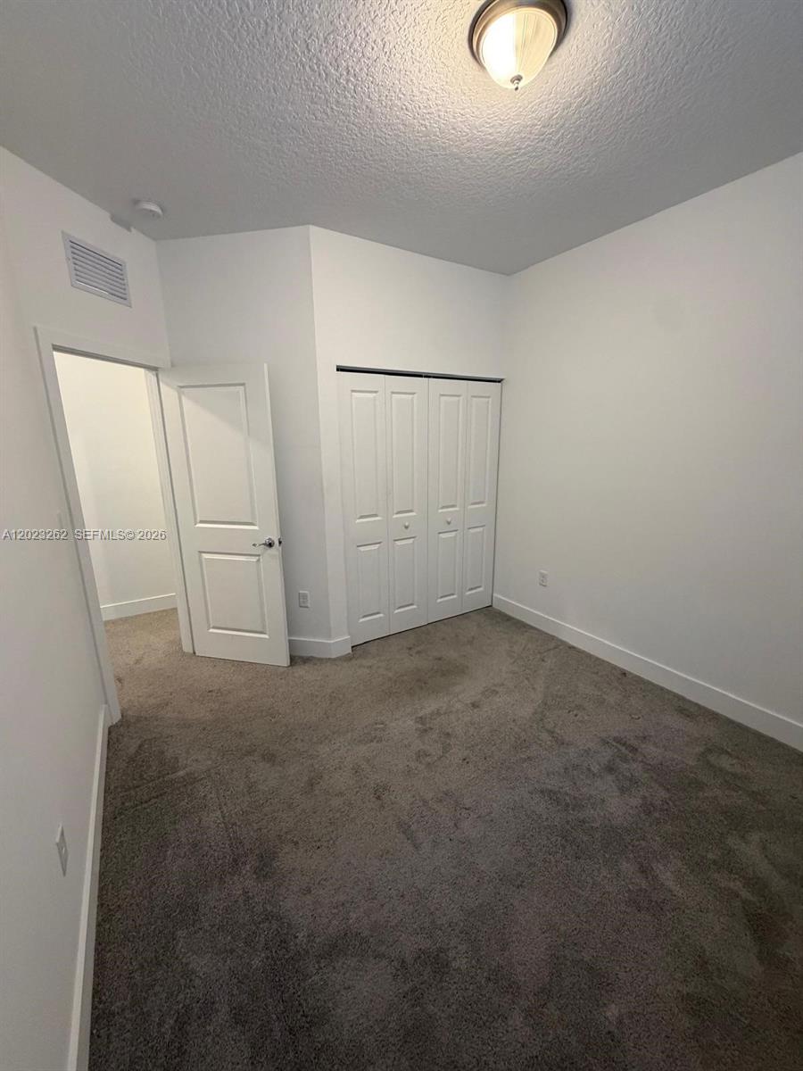 5669 Cerva Lane, Unit 5669 Immokalee, FL 34142 - Photo 22 of 32 an empty room with closet and window