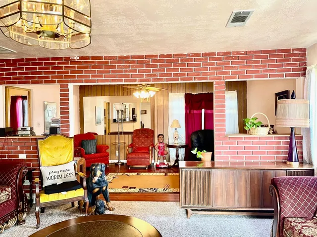 a view of a dinning room with furniture and chandelier