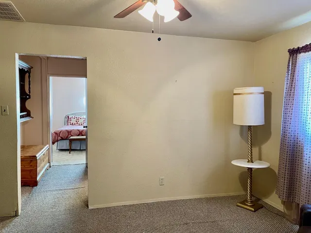 a bedroom with a bed and a lamp