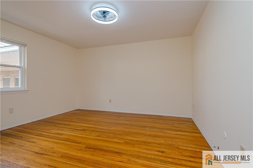 161 Evergreen Road, Unit 12B Edison, NJ 08837 - Photo 12 of 19 an empty room with wooden floor