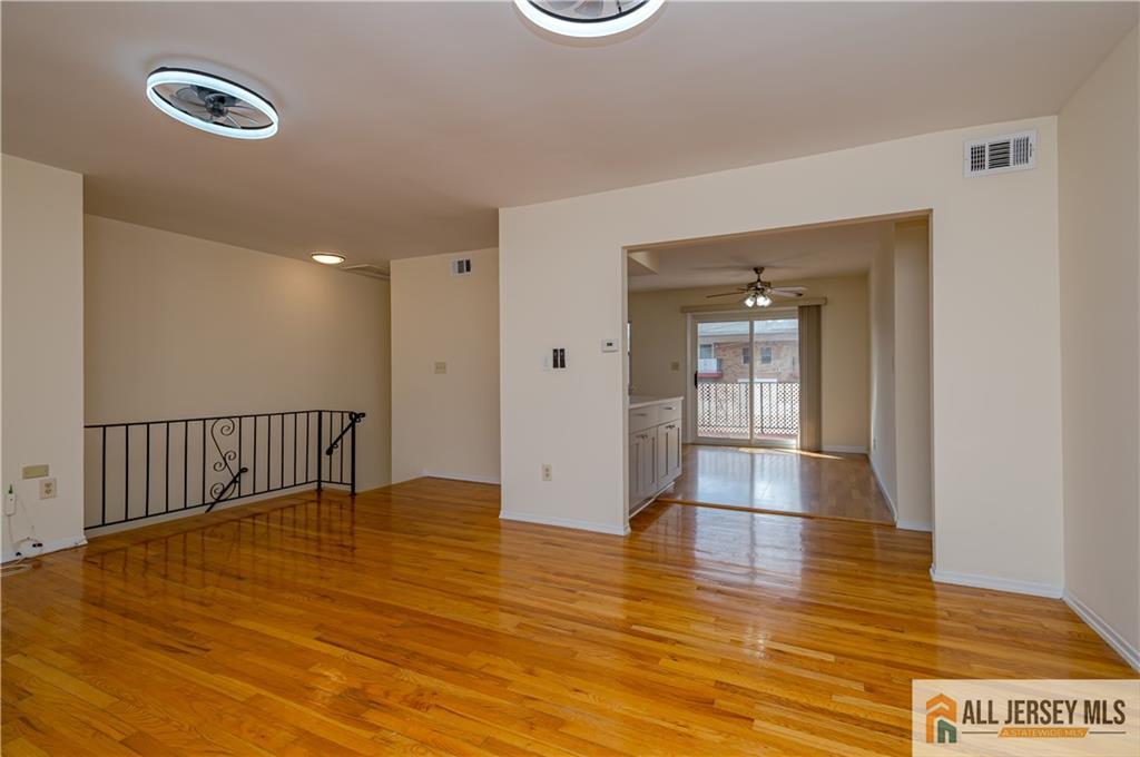 161 Evergreen Road, Unit 12B Edison, NJ 08837 - Photo 5 of 19 a view of a hallway with wooden floor
