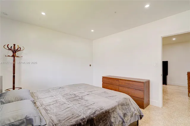 a bedroom with a bed and a night stand