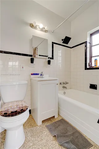 a bathroom with a sink a toilet and bathtub