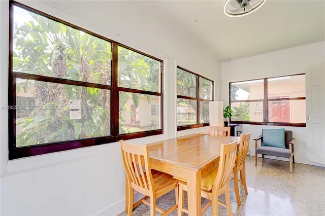 a dining room with furniture and window