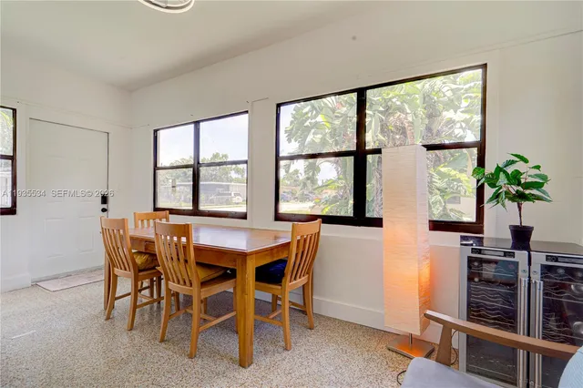 a dining room with furniture and window