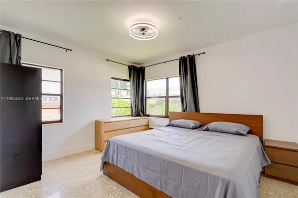 a bedroom with a bed and a window