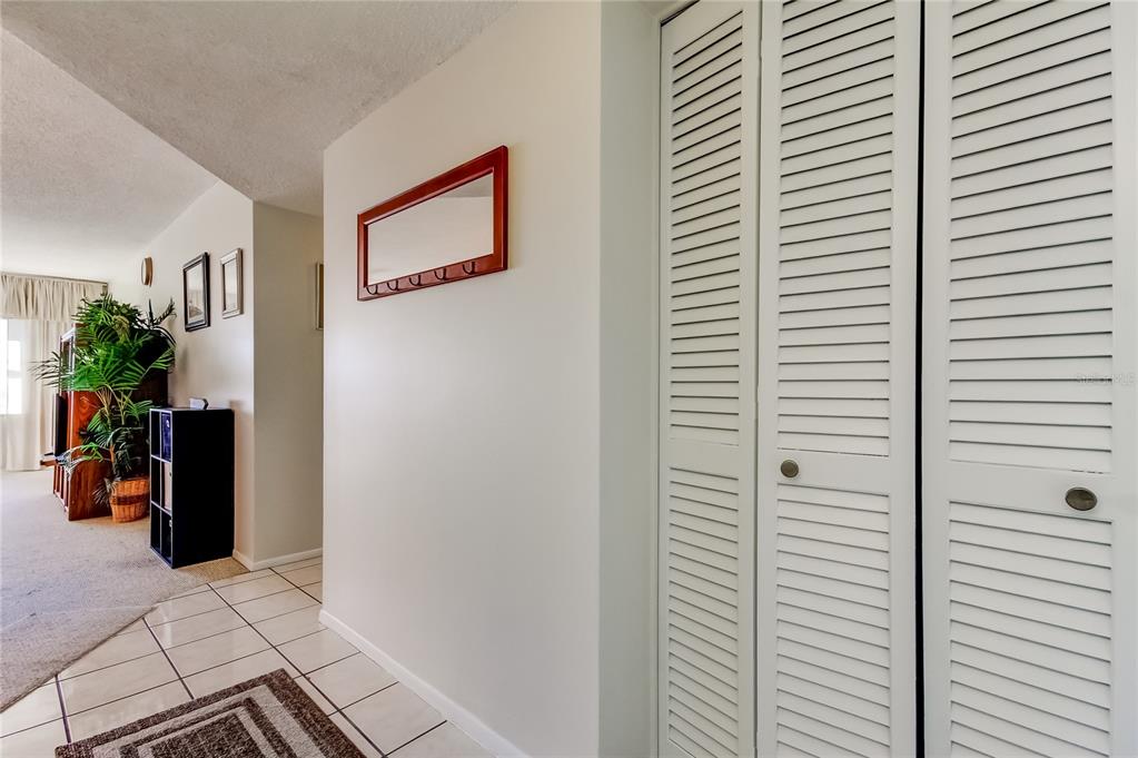 4775 Cove Circle, Unit 1008 St. Petersburg, FL 33708 - Photo 14 of 45 a view of a hallway with workspace and a potted plant