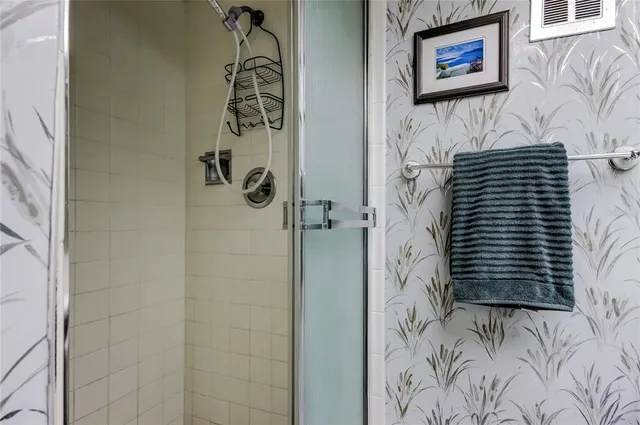 a bathroom with a shower and a sink
