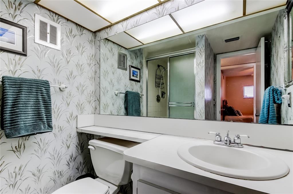 4775 Cove Circle, Unit 1008 St. Petersburg, FL 33708 - Photo 22 of 45 a bathroom with a sink and a mirror