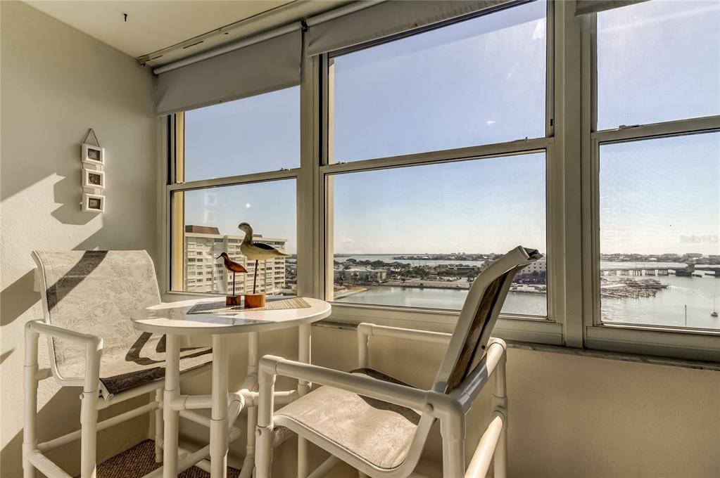4775 Cove Circle, Unit 1008 St. Petersburg, FL 33708 - Photo 24 of 45 a dining room with furniture and a floor to ceiling window