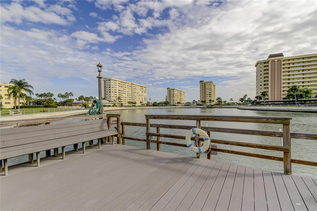 4775 Cove Circle, Unit 1008 St. Petersburg, FL 33708 - Photo 27 of 45 a view of a terrace with outdoor seating and city view