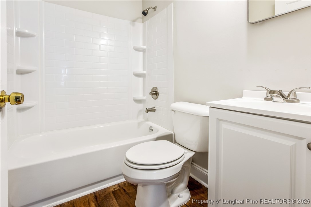 414 Mc Pherson Road Fayetteville, NC 28303 - Photo 15 of 16 a bathroom with a toilet a sink a mirror and bathtub