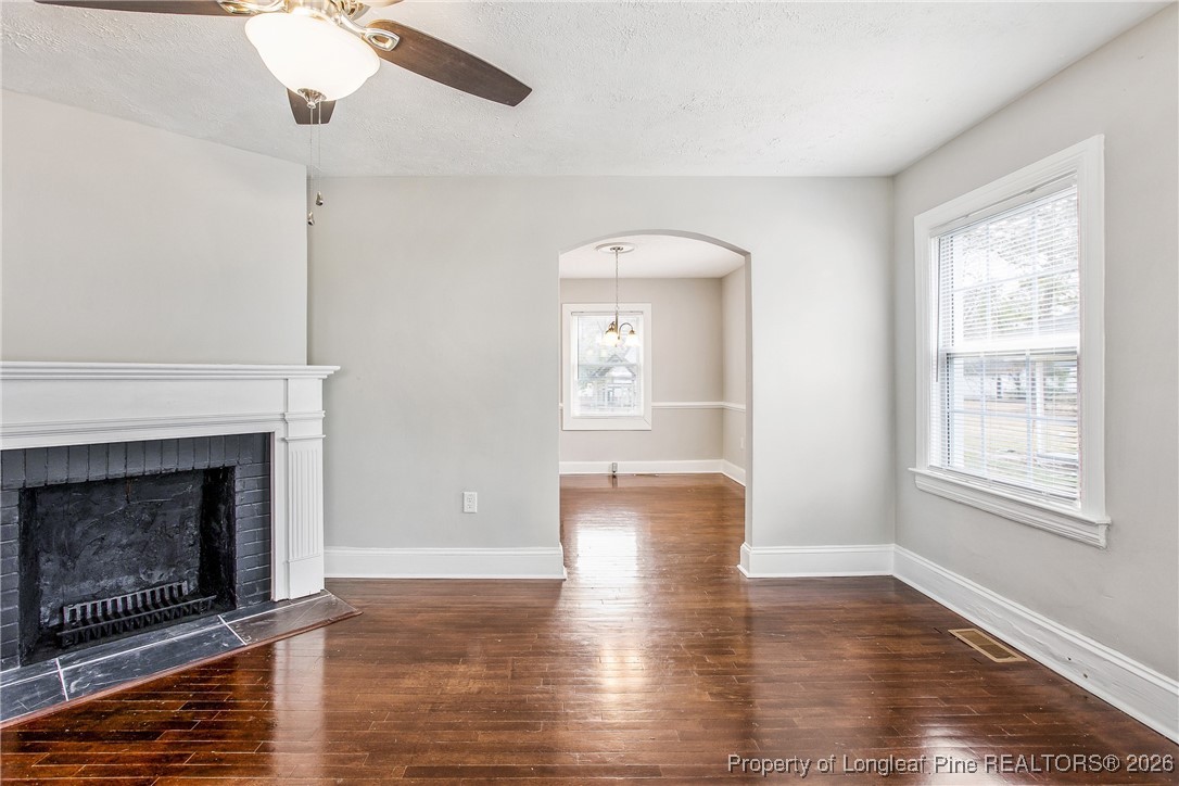 414 Mc Pherson Road Fayetteville, NC 28303 - Photo 3 of 16 a view of an empty room with wooden floor fireplace and a window