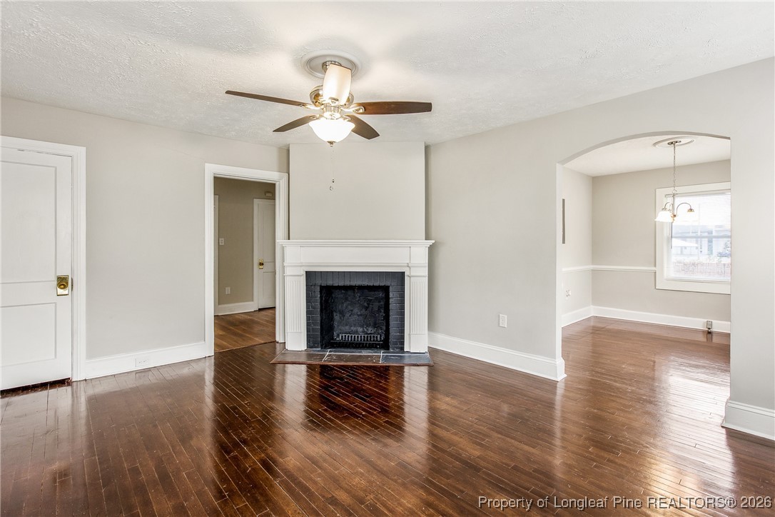 414 Mc Pherson Road Fayetteville, NC 28303 - Photo 4 of 16 a view of a livingroom with wooden floor and a fireplace
