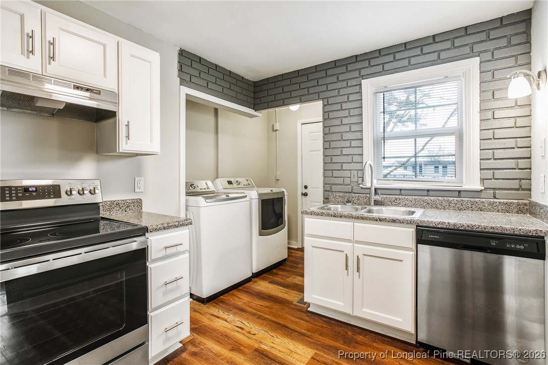 414 Mc Pherson Road Fayetteville, NC 28303 - Photo 8 of 16 a kitchen with stainless steel appliances a stove sink and cabinets