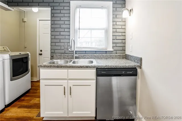 a kitchen with granite countertop white cabinets and white appliances