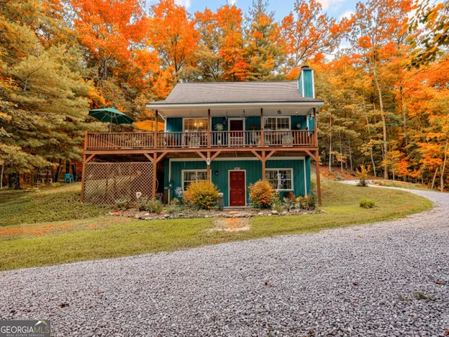 a view of a house with swimming pool and sitting area