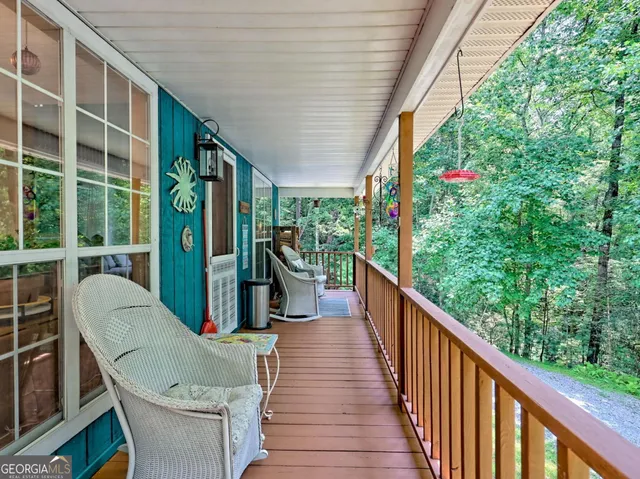 a balcony with furniture and a potted plant