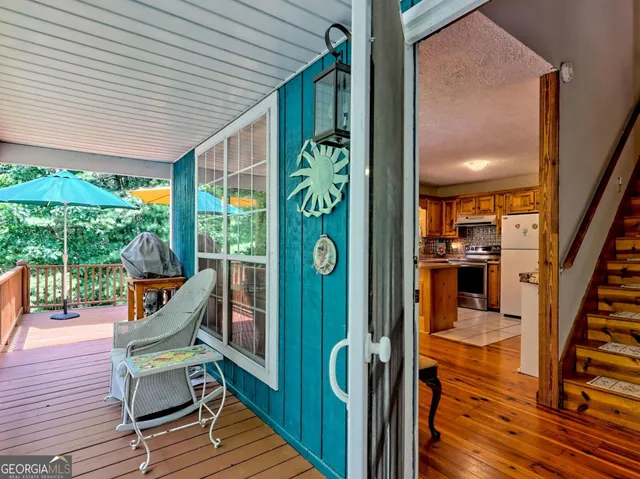 a dining room with furniture a chandelier and wooden floor