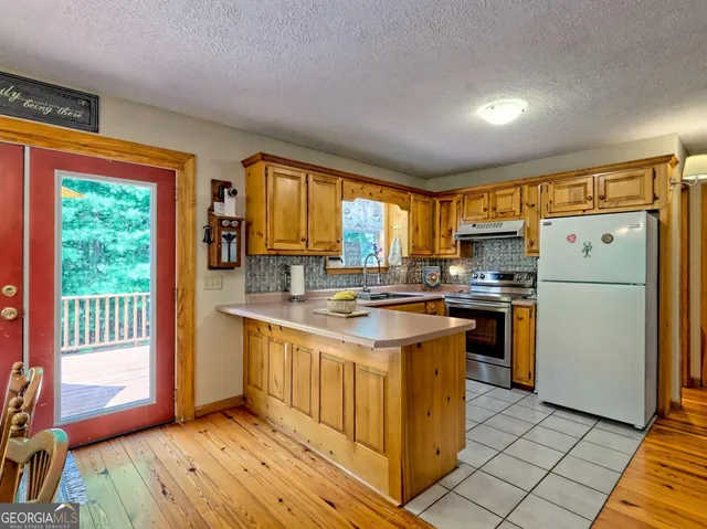 a kitchen that has a sink and a stove top oven