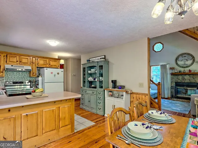 a kitchen with a refrigerator and a stove
