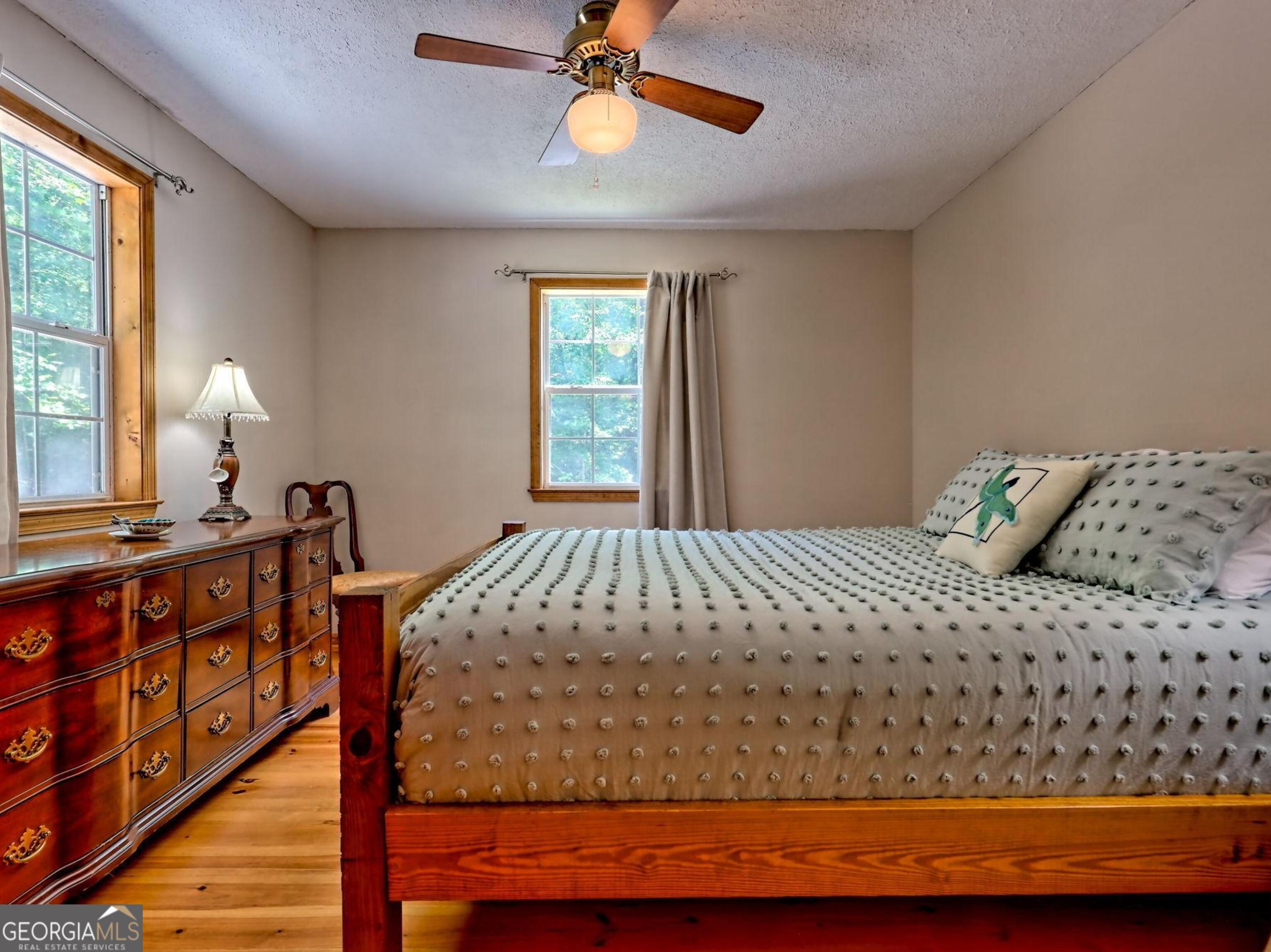 249 Spruce Creek Road Lakemont, GA 30552 - Photo 25 of 55 a bedroom with a bed and window