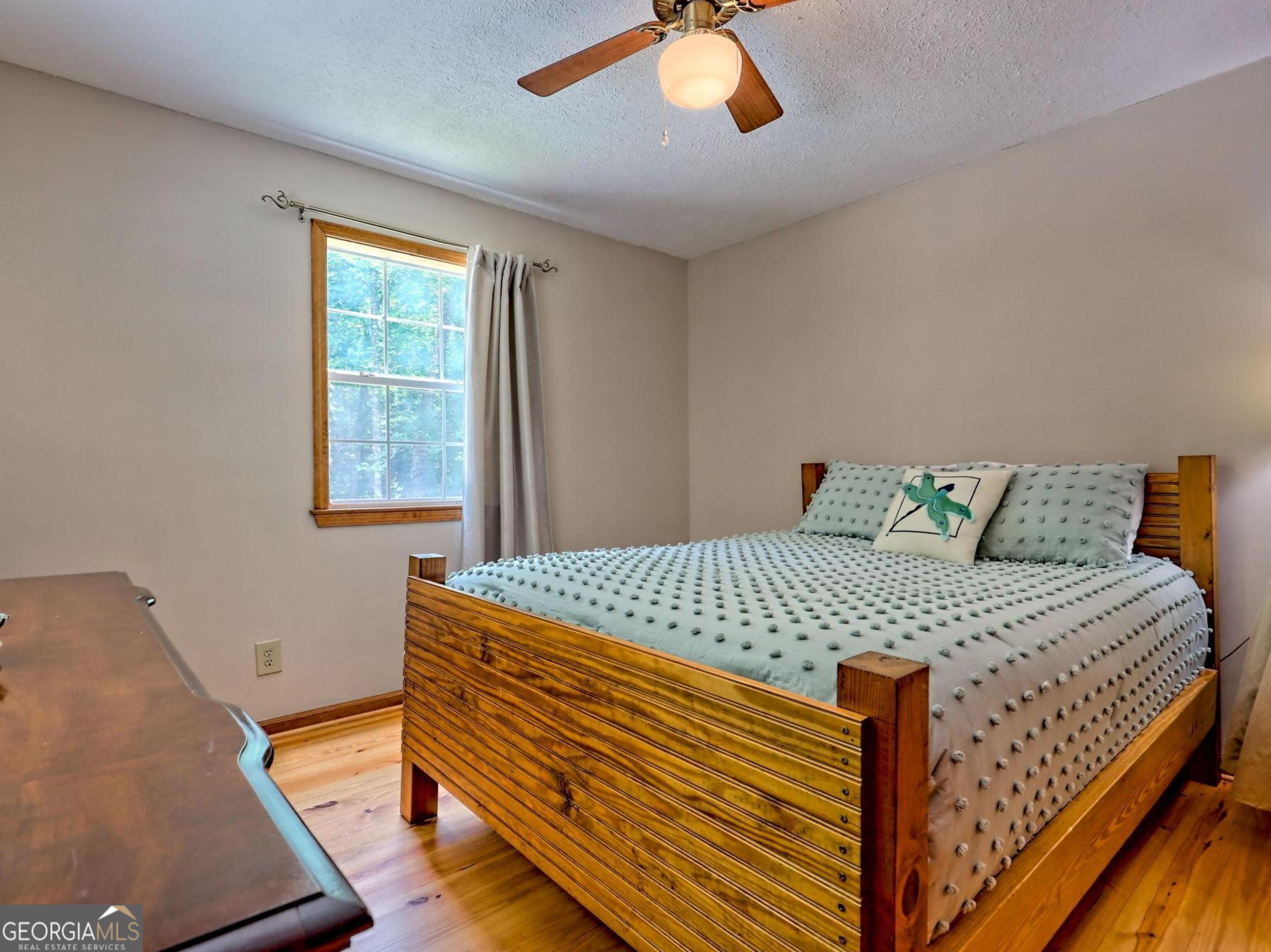249 Spruce Creek Road Lakemont, GA 30552 - Photo 26 of 55 a bed sitting in a bedroom next to a window