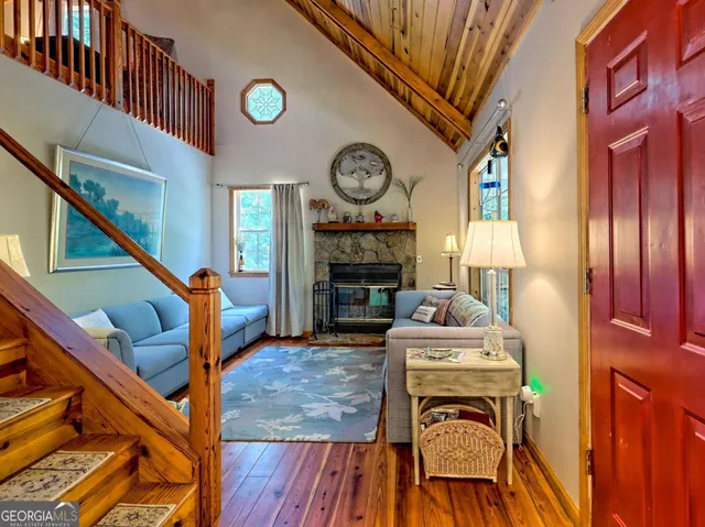 a living room with furniture a clock and a fireplace