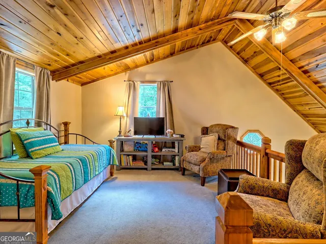 a bedroom with furniture and a chandelier