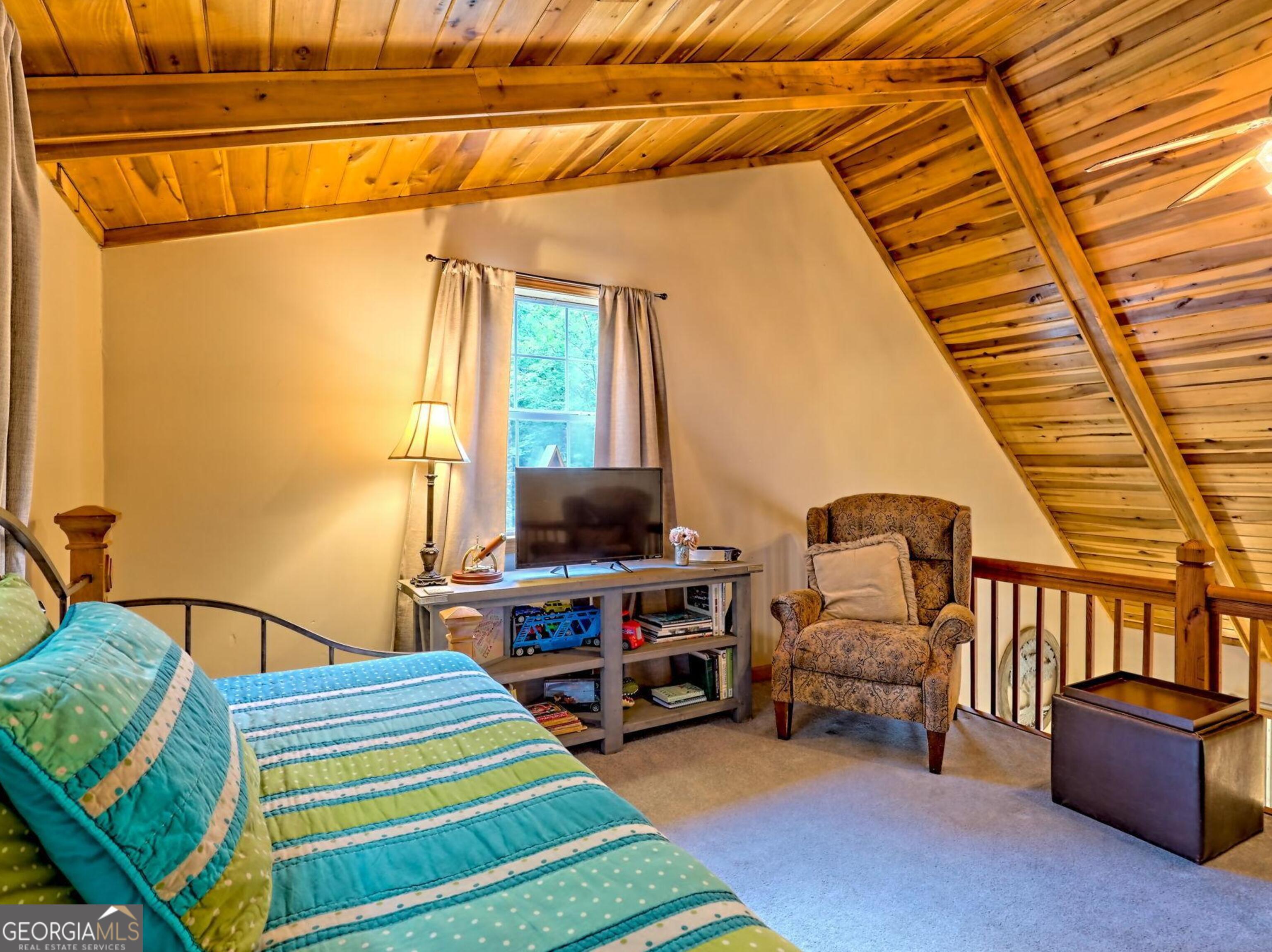 249 Spruce Creek Road Lakemont, GA 30552 - Photo 35 of 55 a room with furniture and a flat screen tv