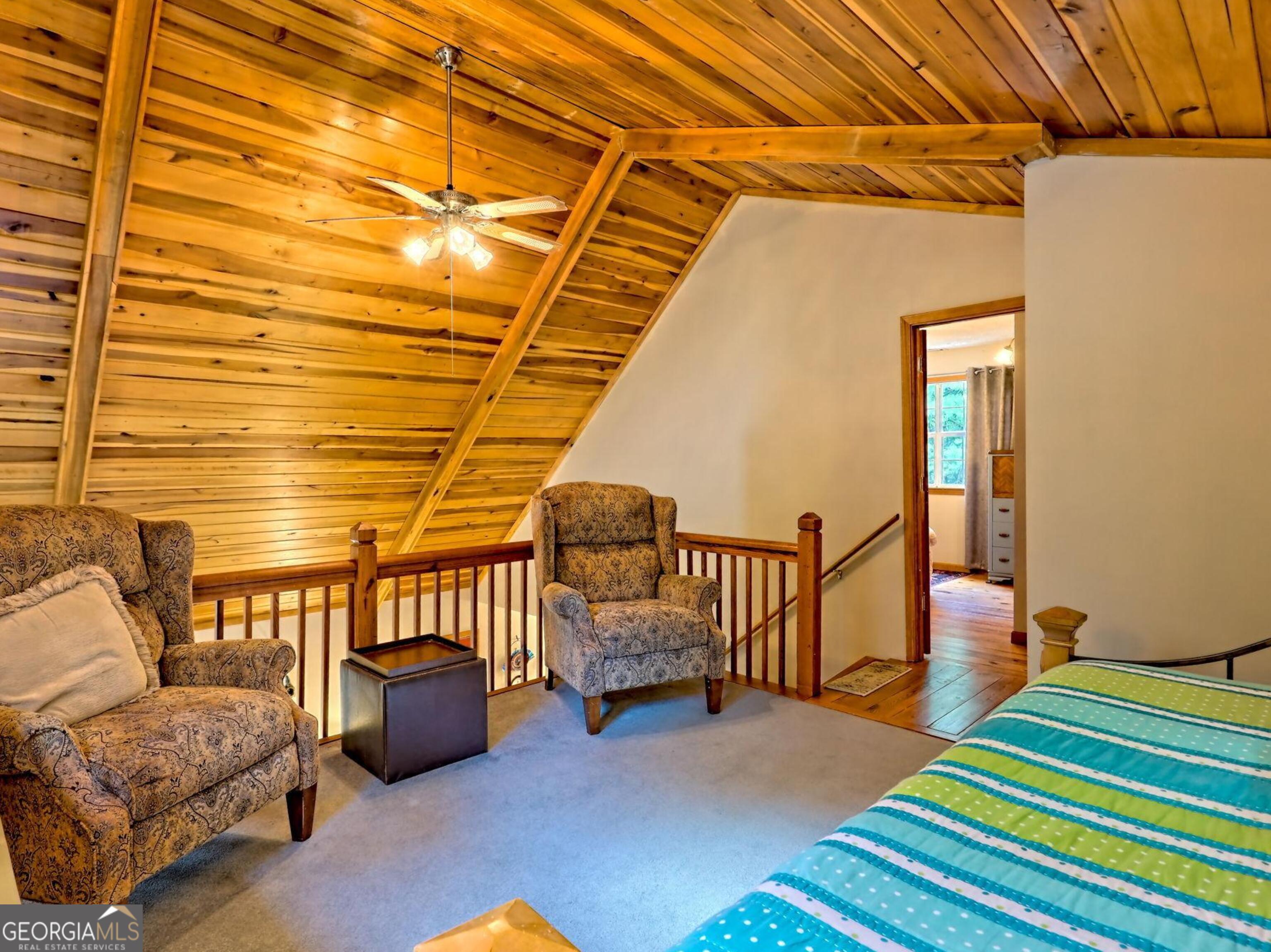 249 Spruce Creek Road Lakemont, GA 30552 - Photo 36 of 55 a bedroom with furniture and a rug