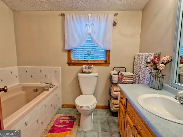 a living room with furniture a fireplace and a large window