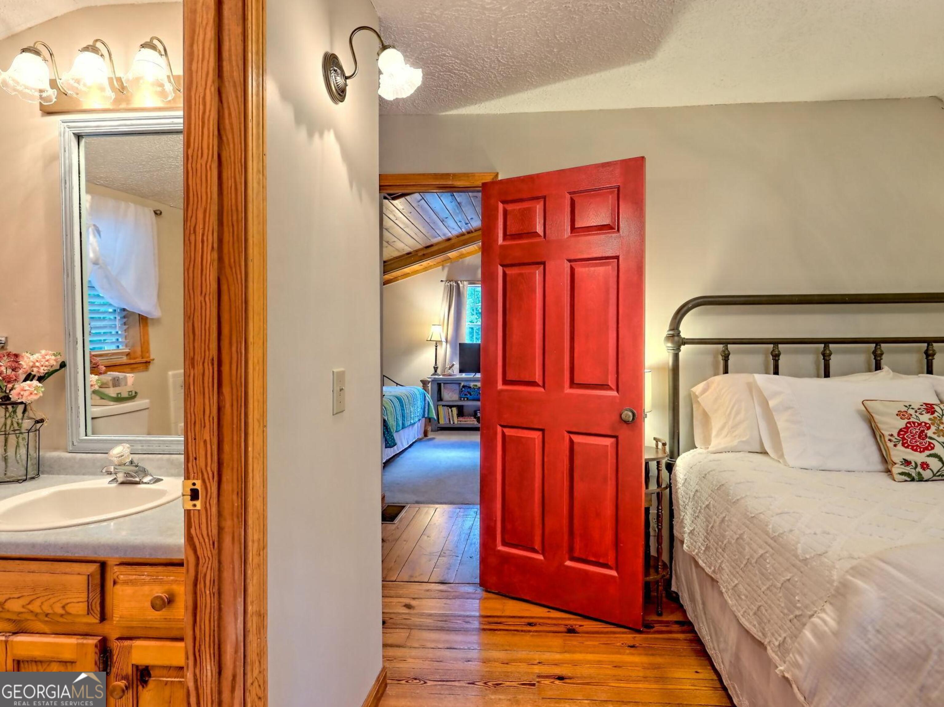 249 Spruce Creek Road Lakemont, GA 30552 - Photo 41 of 55 a bedroom with a bed and wooden floor