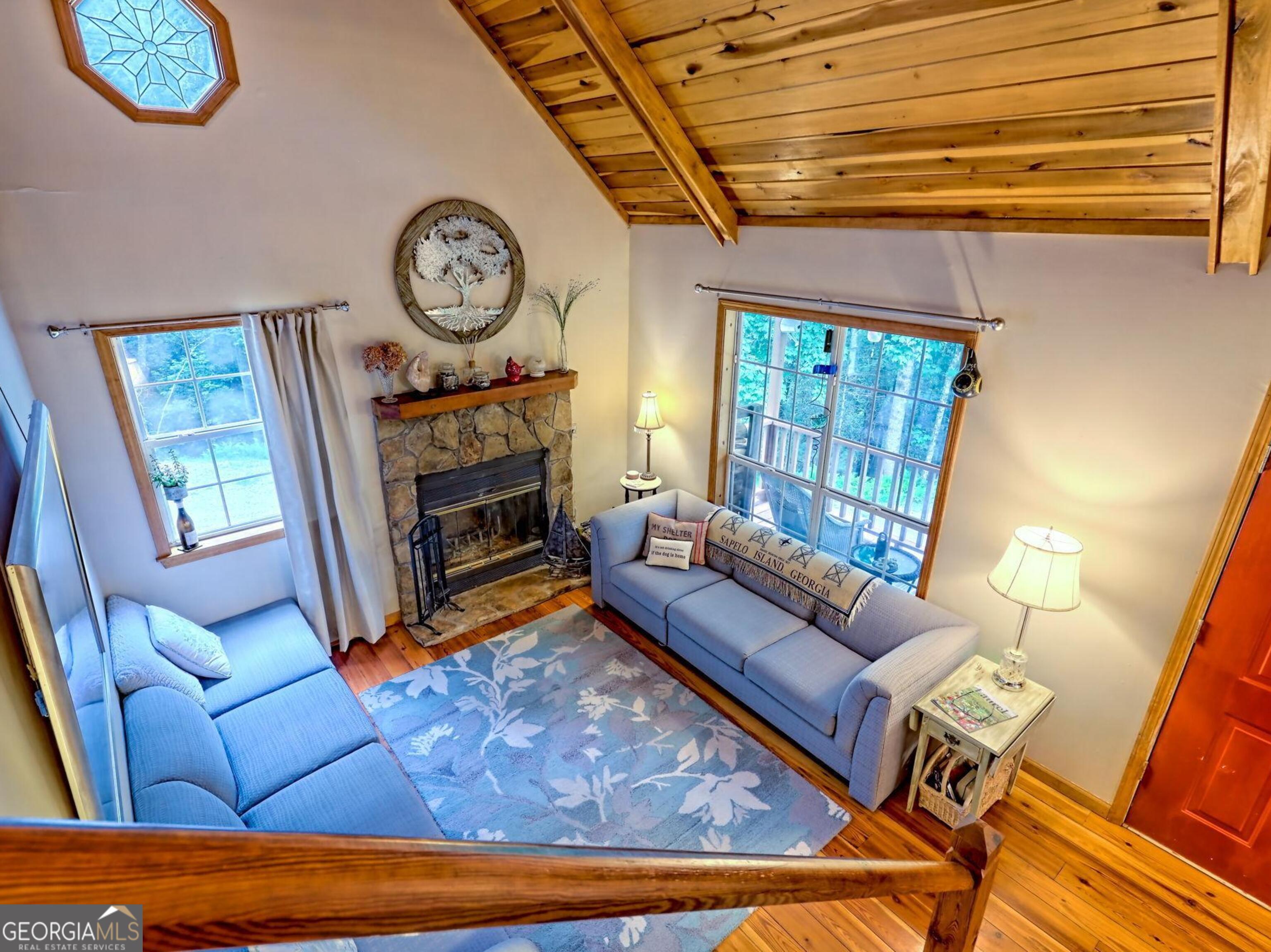 249 Spruce Creek Road Lakemont, GA 30552 - Photo 43 of 55 a living room with furniture a fireplace and a large window