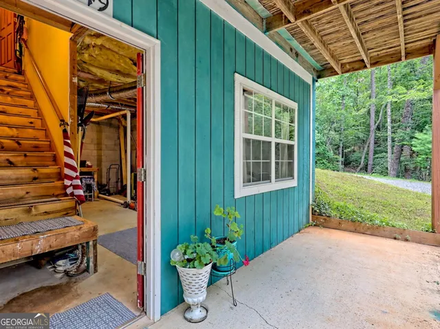 a backyard of a house with table and chairs