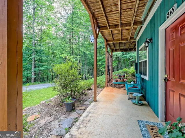 a view of backyard with outdoor seating and green space