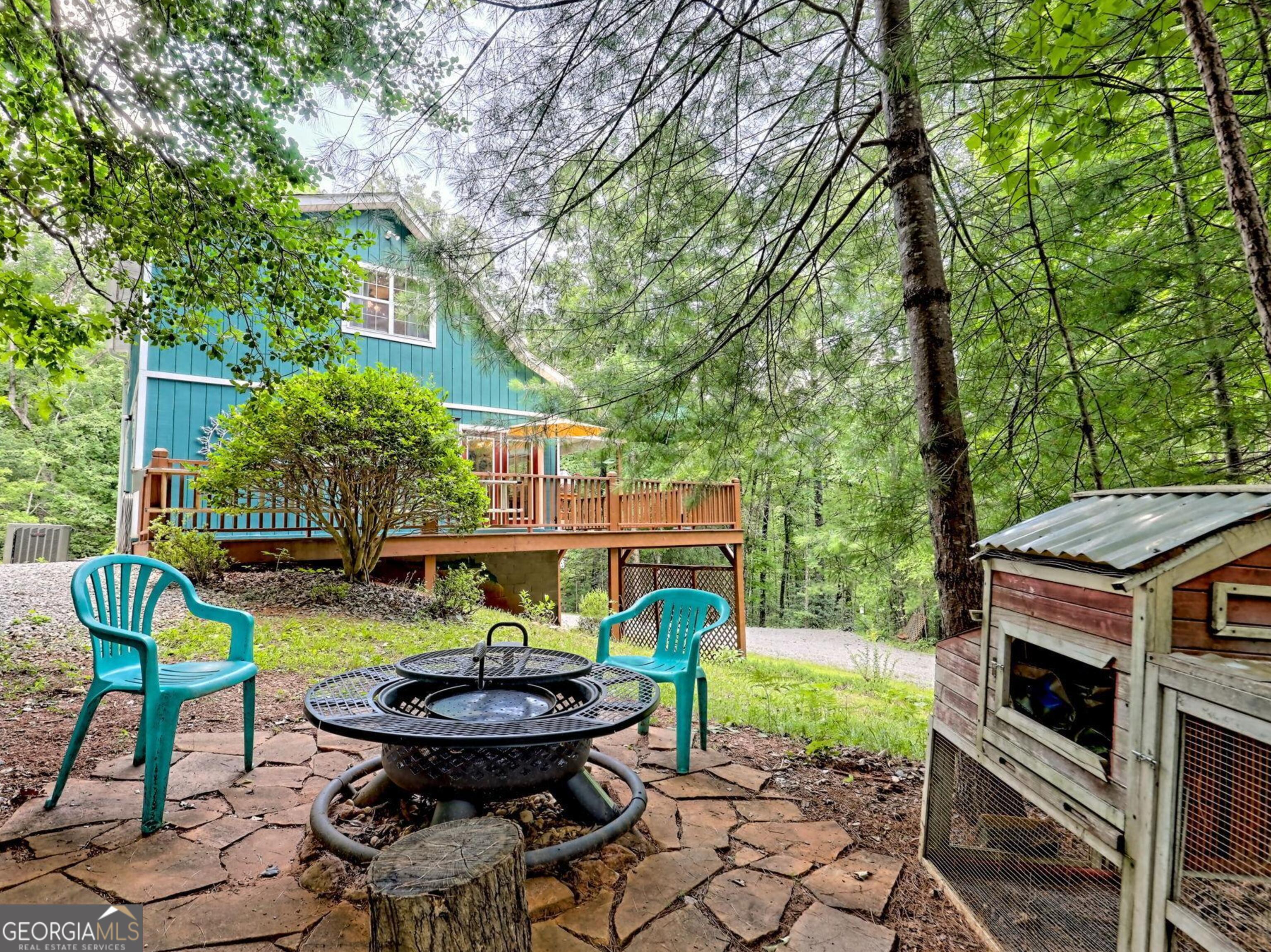 249 Spruce Creek Road Lakemont, GA 30552 - Photo 54 of 55 a backyard of a house with table and chairs
