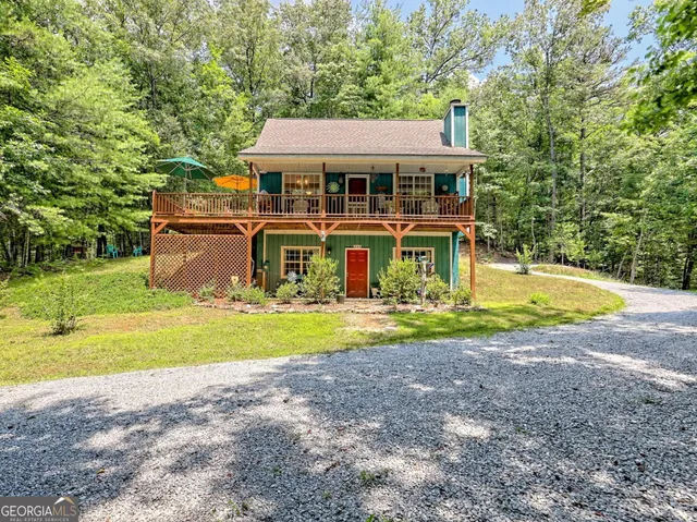 a view of a house with pool and a yard