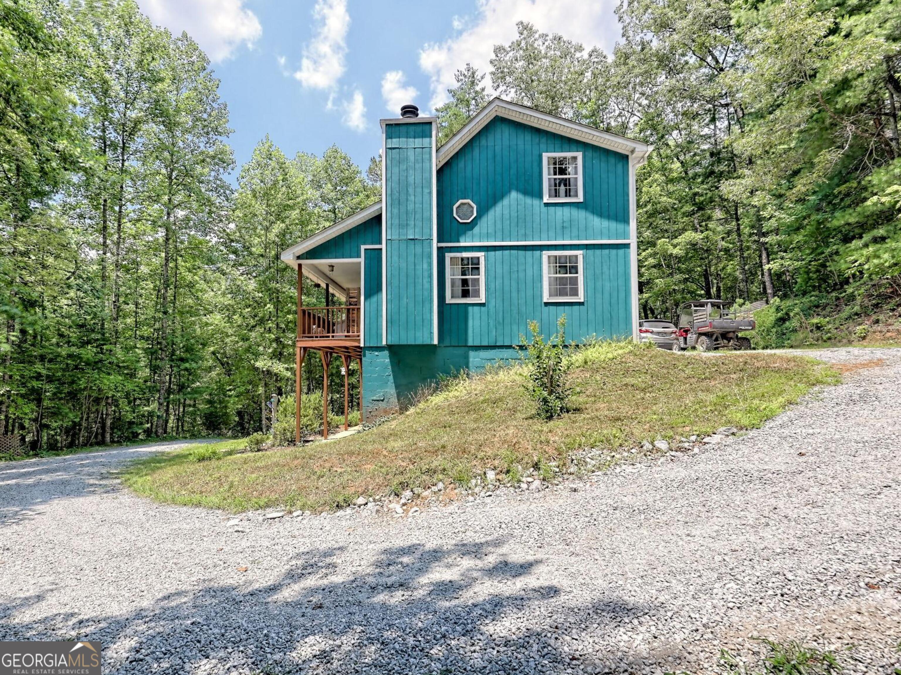 249 Spruce Creek Road Lakemont, GA 30552 - Photo 8 of 55 a view of a brick house next to a yard with large trees