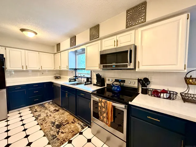 a kitchen with a sink stove and microwave