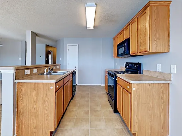 a kitchen with stainless steel appliances granite countertop a sink and cabinets