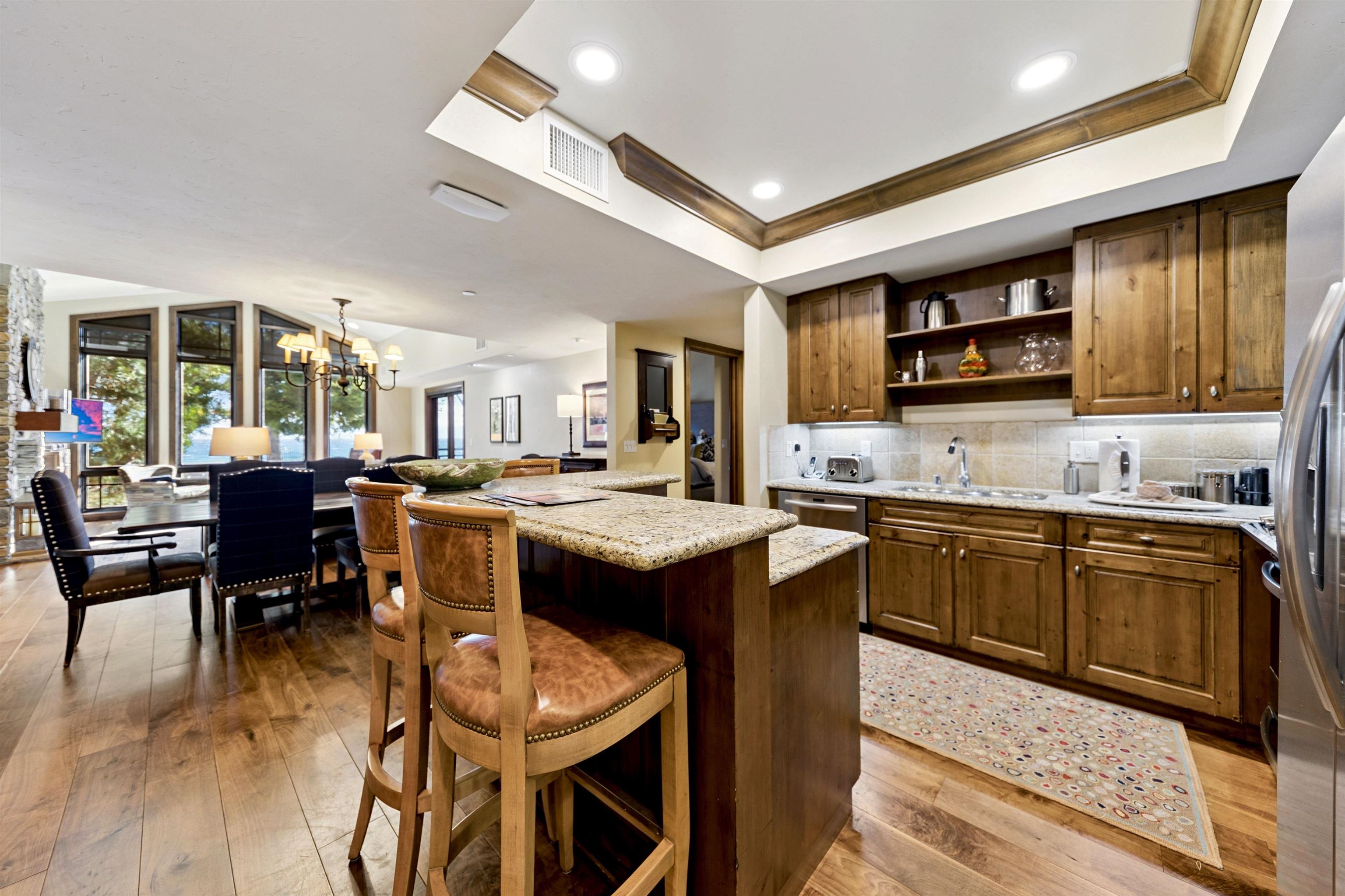 6750 North Lake Boulevard, Unit 10B Tahoe Vista, CA 96148 - Photo 12 of 23 a kitchen with a table chairs sink and cabinets