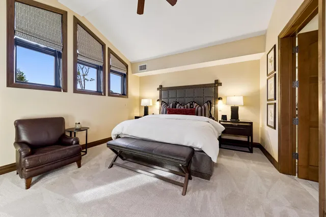 a bed room with a bed and a chair