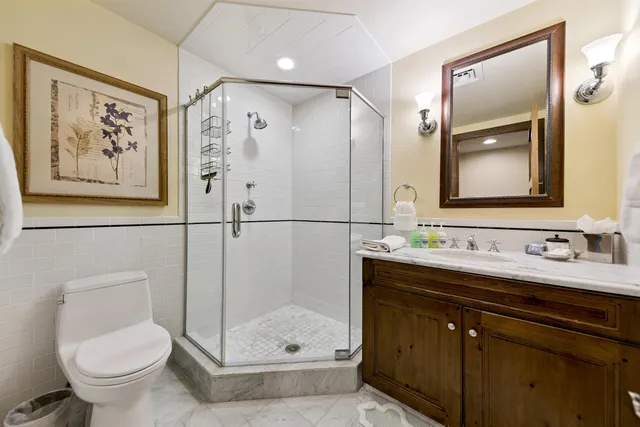 a bathroom with a shower sink and mirror