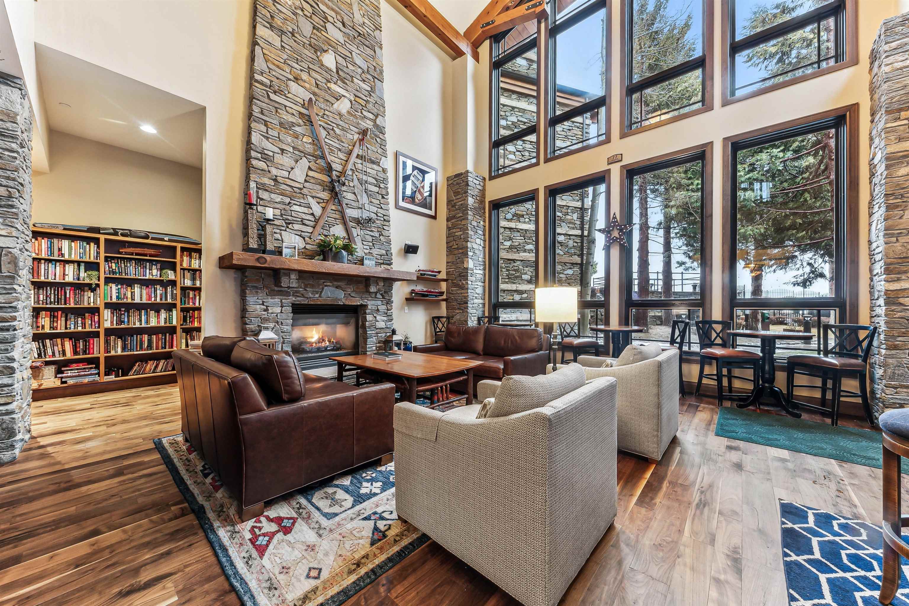 6750 North Lake Boulevard, Unit 10B Tahoe Vista, CA 96148 - Photo 22 of 23 a living room with furniture a fireplace and a floor to ceiling window