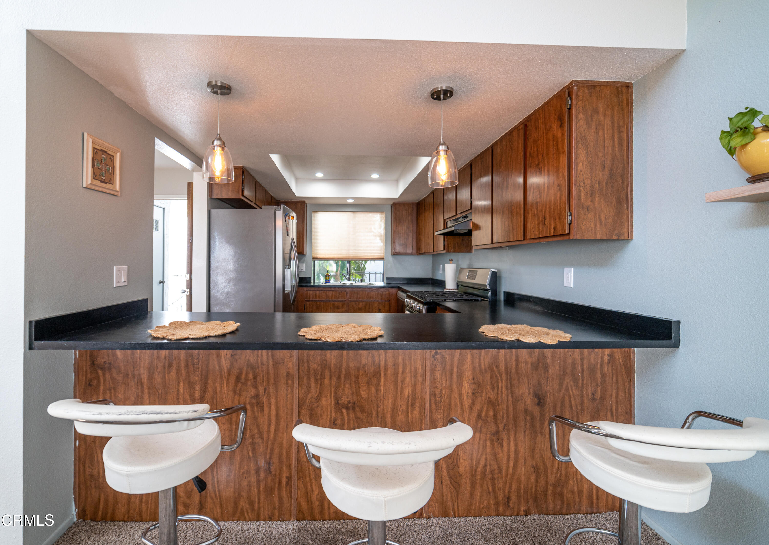 5170 Longfellow Way Oxnard, CA 93033 - Photo 5 of 12 a kitchen with a table and chairs