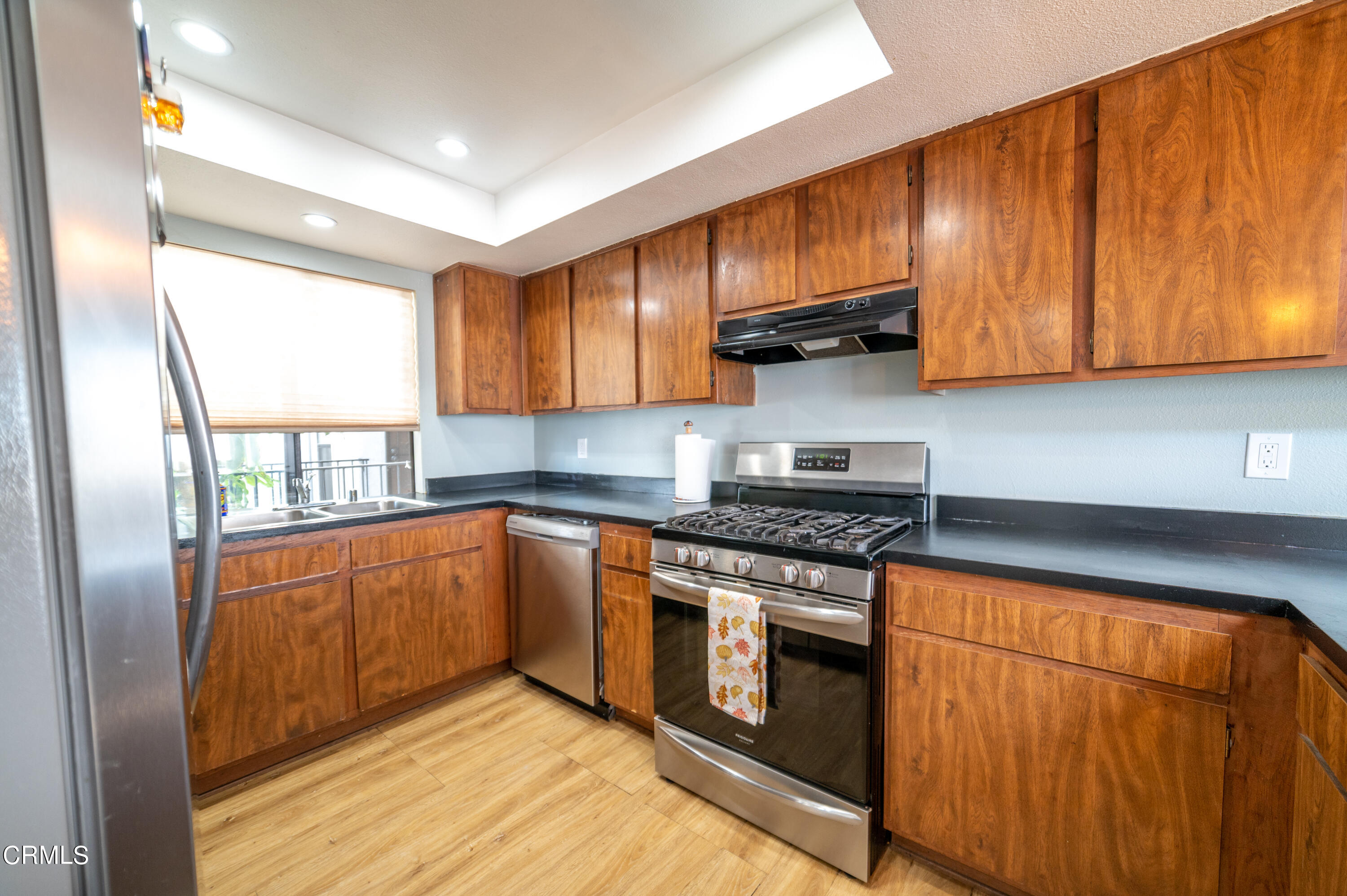 5170 Longfellow Way Oxnard, CA 93033 - Photo 6 of 12 a kitchen with stainless steel appliances granite countertop a stove a sink and a refrigerator