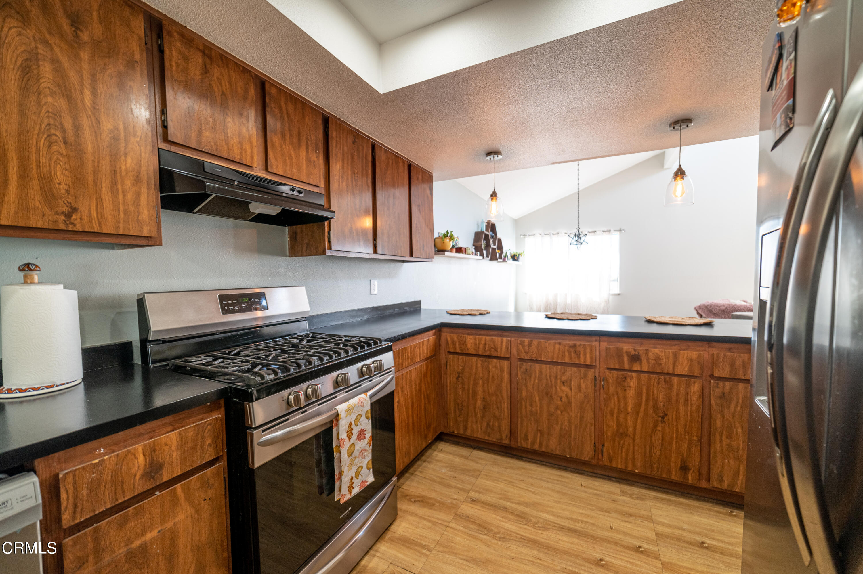 5170 Longfellow Way Oxnard, CA 93033 - Photo 7 of 12 a kitchen with stainless steel appliances granite countertop a stove a sink dishwasher and a refrigerator